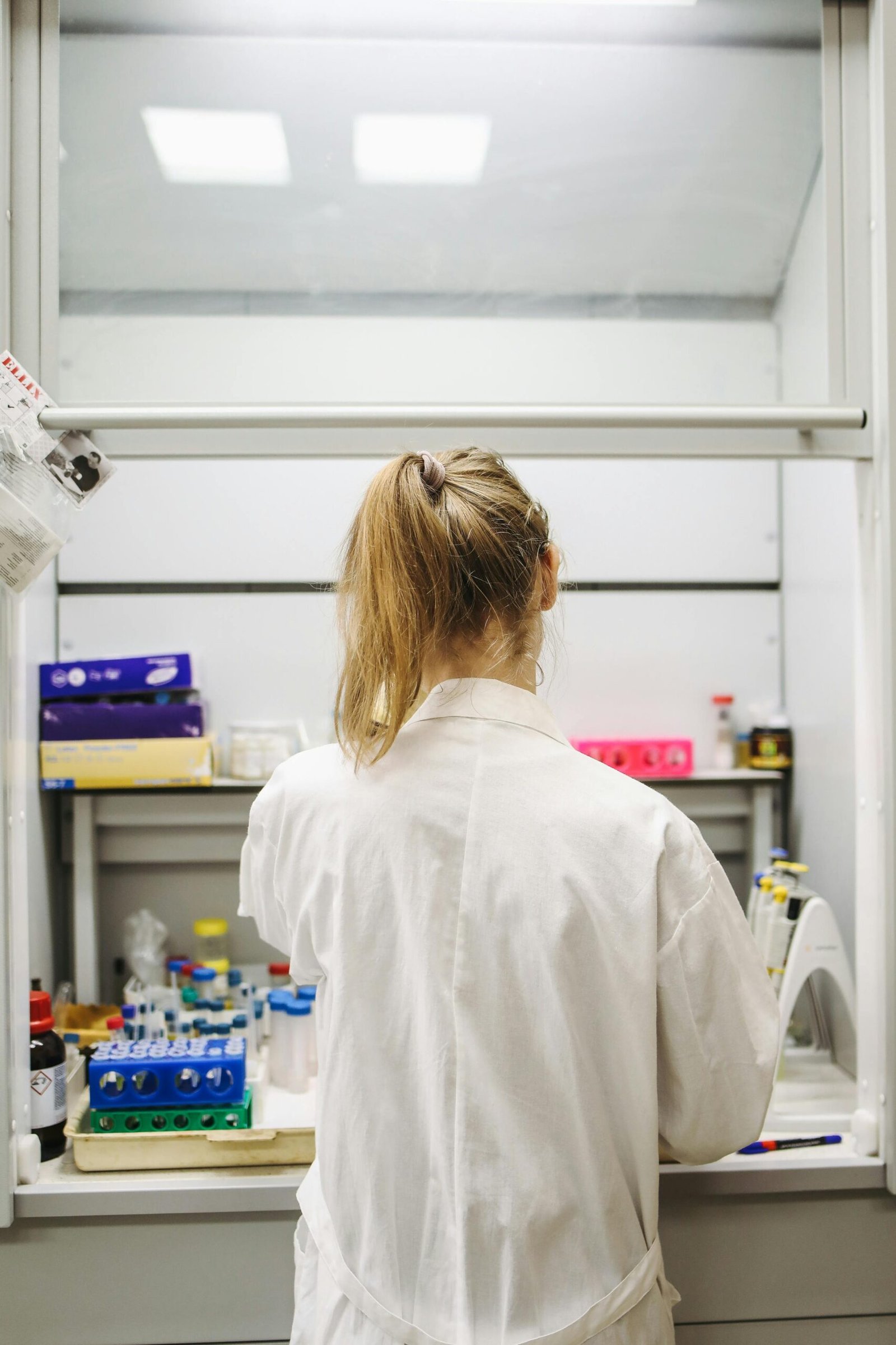 pexels-photo-3735726-3735726 A female scientist seen from behind working in a modern laboratory setting.