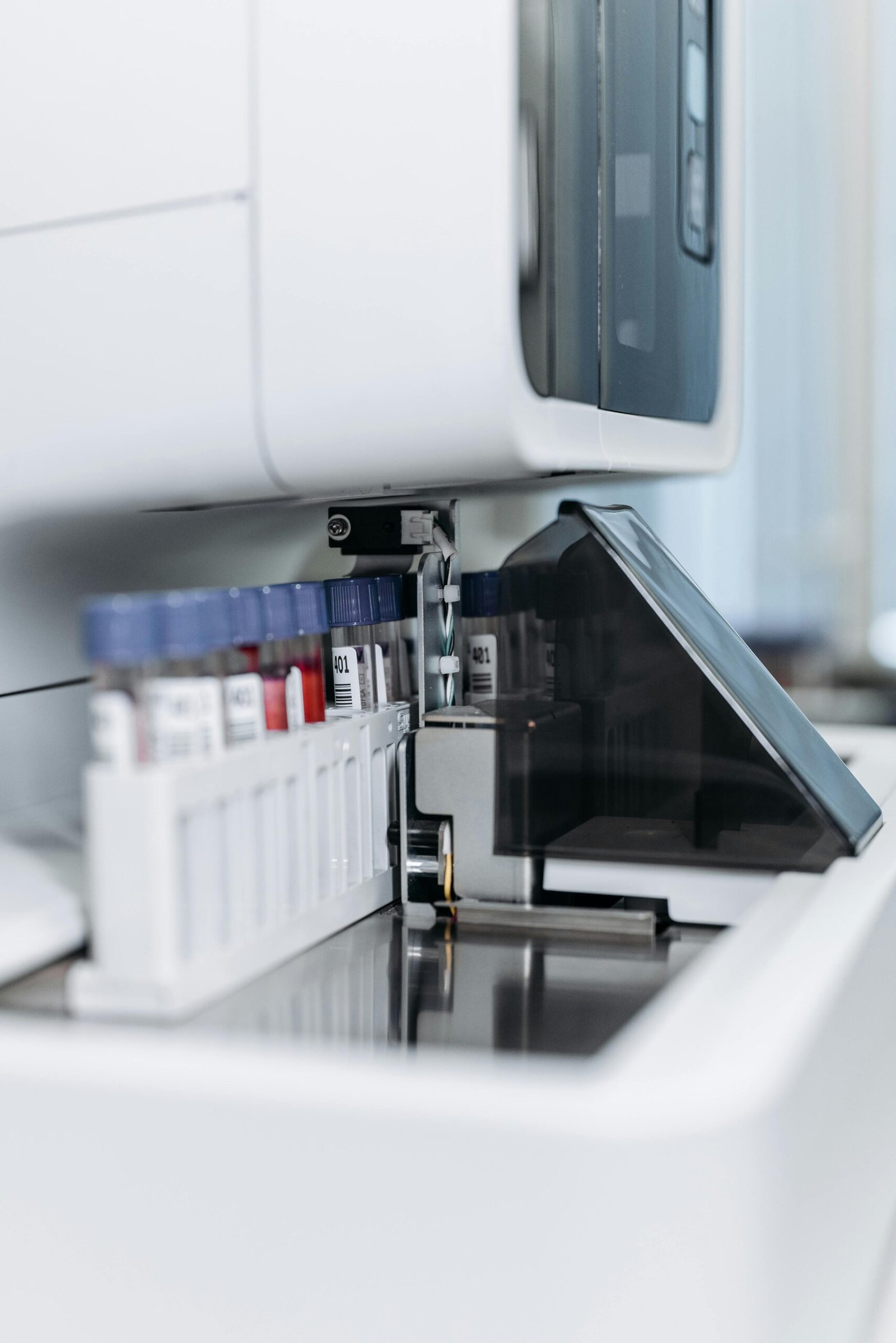 pexels-photo-8442446-8442446 Close-up of an automated laboratory machine handling test tubes for research.
